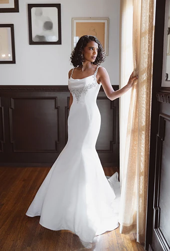 Bride wearing simple fit-and-flare wedding dress with beaded straps and bodice details, Essense of Australia d4609