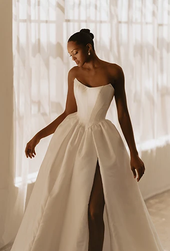 Bride wearing strapless ballgown wedding dress with cat-eye neckline and basque waist, Martina Liana ML1962