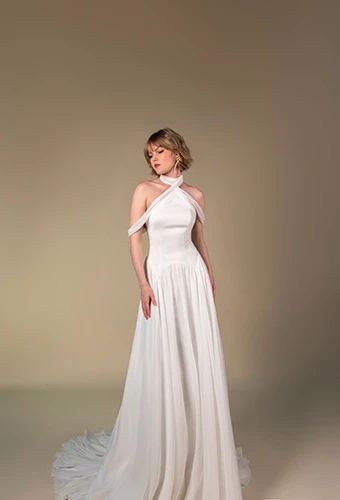 Bride wearing chiffon A-line gown with asymmetrical neckline and drop waist, All Who Wander falon