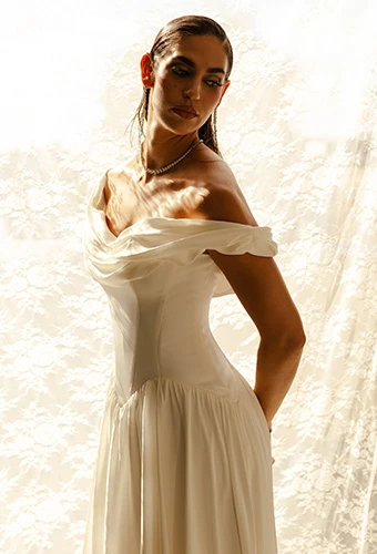 Bride wearing simple a line wedding gown with off the shoulder straps