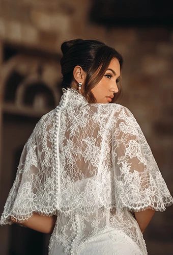 Bride wearing fit-and-flare wedding dress with detachable lace high-neck bridal cape, Martina Liana ml2010