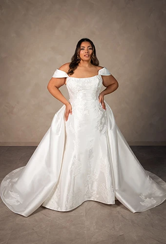 Plus size bride wearing Mikado mermaid wedding dress with off-shoulder straps and overskirt, Essense of Australia D4493+