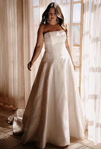 Plus size bride wearing strapless Mikado A-line gown with simple floral motifs, Martina Liana ML2062+