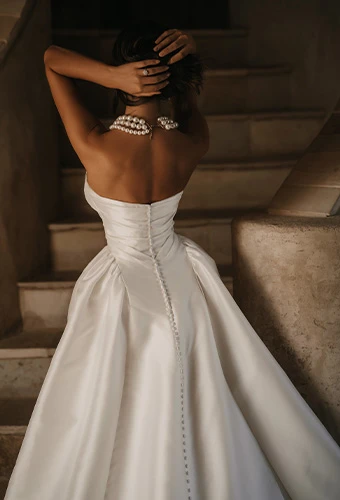 Bride wearing minimalistic strapless ballgown wedding dress