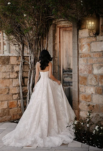 Bride wearing voluminous A-line wedding gown with scalloped lace train, Martina Liana ML2070