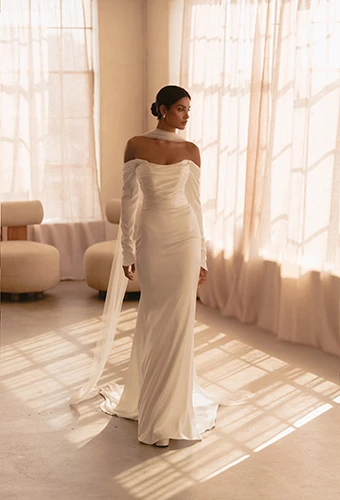 Bride wearing simple strapless wedding dress with ruched bodice and long sleeves, Martina Liana ML1997