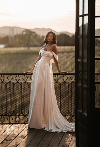 Bride wearing minimalist A-line wedding dress with off shoulder sleeves, Martina Liana ML2066
