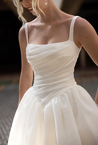 Close up of simple wedding dress bodice with draping and drop waist, Essense of Australia D4484
