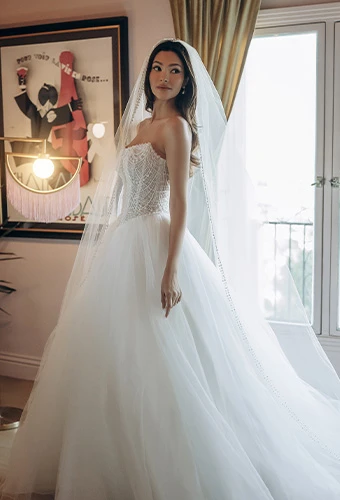 Bride wearing glamorous strapless ballgown wedding dress with beaded bodice