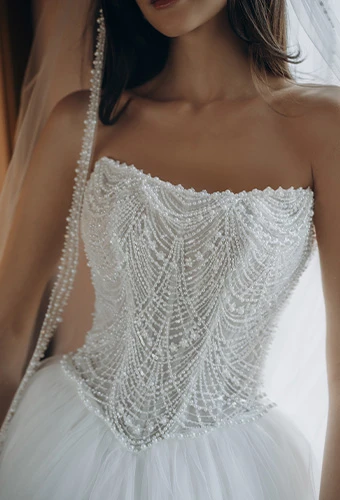 Bride wearing strapless ballgown wedding dress with intricate beading on the bodice
