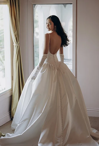Bride wearing ballgown wedding dress with open back and thin spaghetti straps