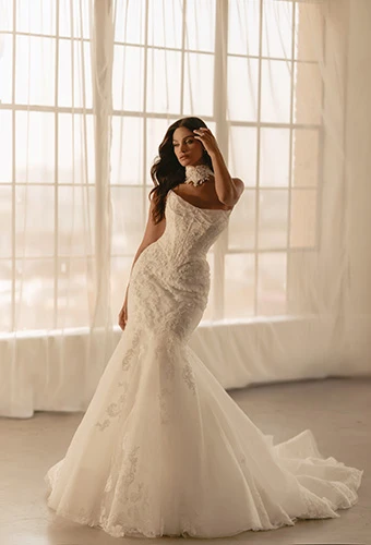 Bride wearing faux two-piece trumpet wedding dress with cat eye neckline and draped beading, Martina Liana ML1950