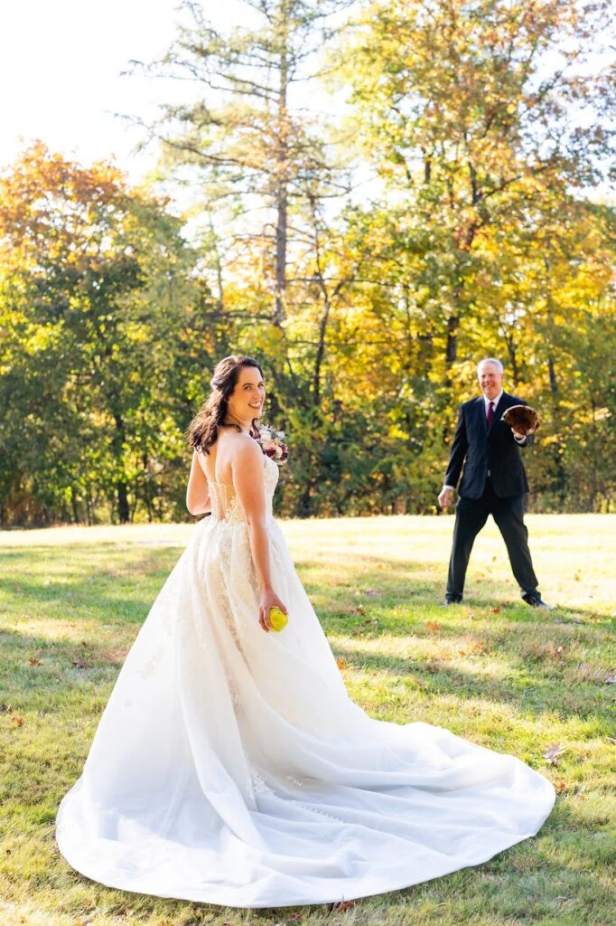 Real bride Melissa doing a softball catch in her wedding gown