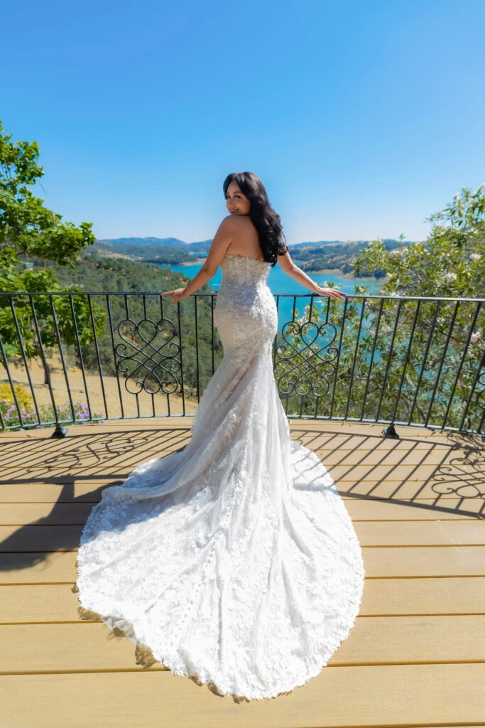 Real bride Perlissa posing in her wedding gown on balcony