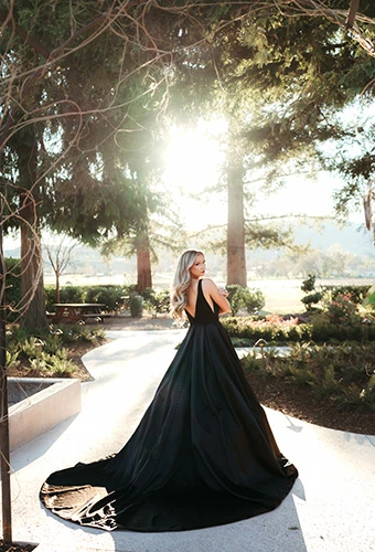 Bride wearing voluminous black A-line wedding dress, Stella York SY7755BLK