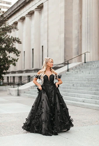 Bride wearing black ballgown wedding dress with off shoulder straps, plunging neckline and 3D florals, Essense of Australia D3734BLK