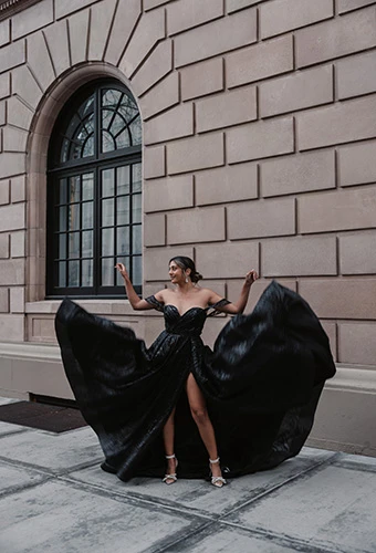 Bride showing off shimmering black wedding dress with off-the-shoulder straps and sweetheart neckline, Essense of Australia D3648BLK