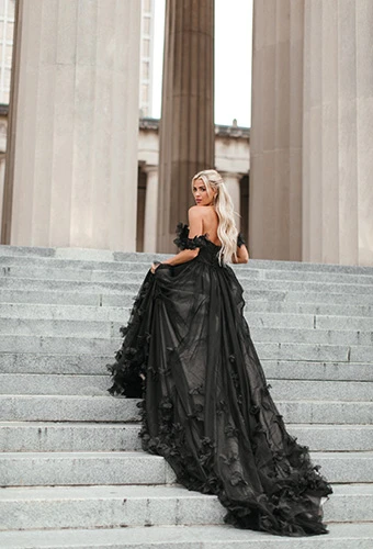 Bride showing train of black wedding dress detailed with sheer tulle and 3D florals, Essense of Australia D3734BLK