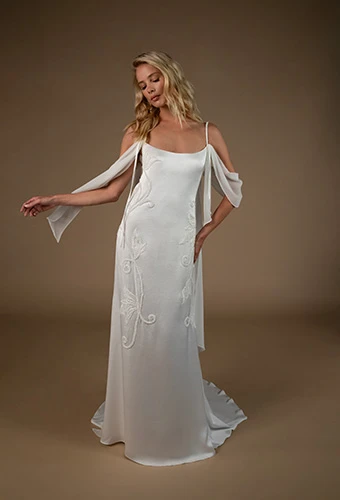 Bride wearing boho column wedding dress with beaded floral details and arm wraps, All Who Wander annica