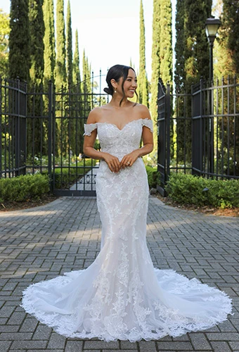 Bride wearing fit-and-flare wedding dress with off-shoulder straps and beaded sequins, Essense of Australia D3960