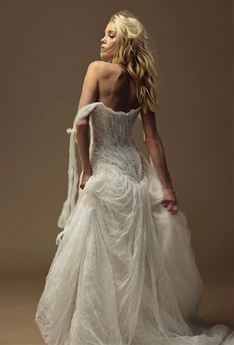 Bride wearing lace wedding dress with off the shoulder straps