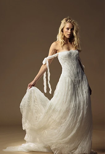 Bride wearing a line lace wedding gown with off the shoulder straps and straight across neckline
