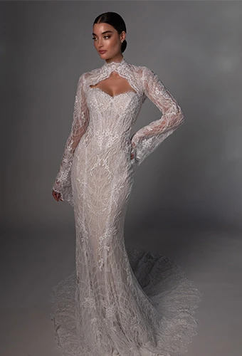 Bride wearing lace wedding gown with long sleeves and high neckline