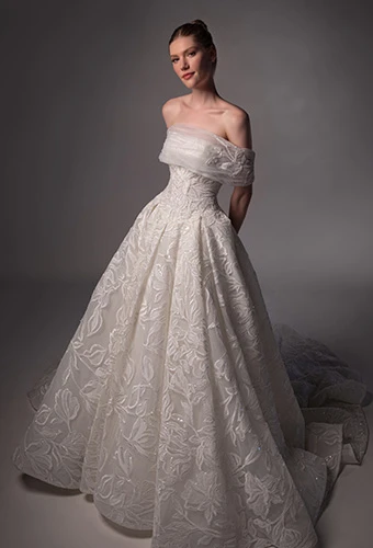 Bride wearing lace ballgown wedding dress with detachable shawl