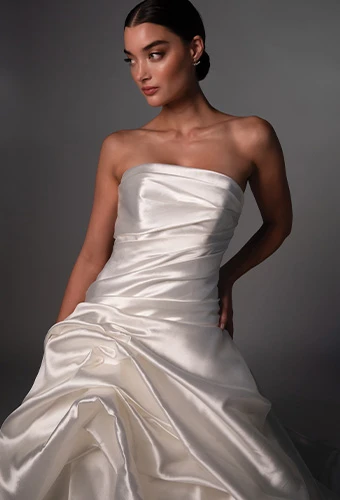 Bride wearing strapless wedding gown with draping