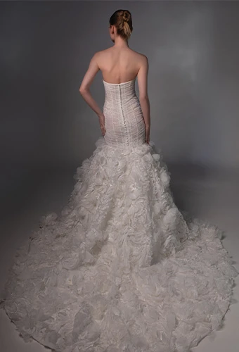 Bride wearing strapless mermaid wedding gown with lace skirt and train