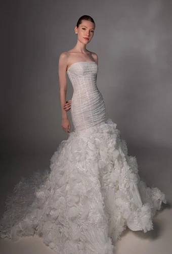 Bride wearing strapless mermaid wedding dress with straight across neckline and lace skirt