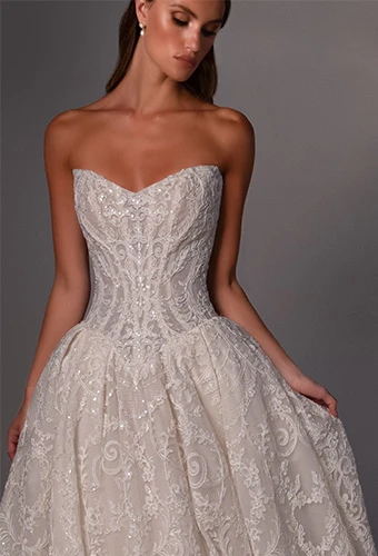 Bride wearing strapless ballgown wedding dress with beaded lace and sweetheart neckline