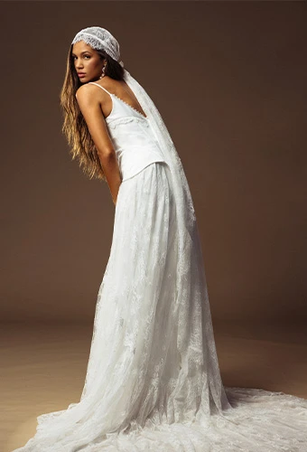 Bride wearing faux two piece wedding dress with lace skirt