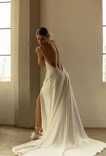 Bride wearing minimalist satin wedding dress with low back and zipper closure, All Who Wander rianna