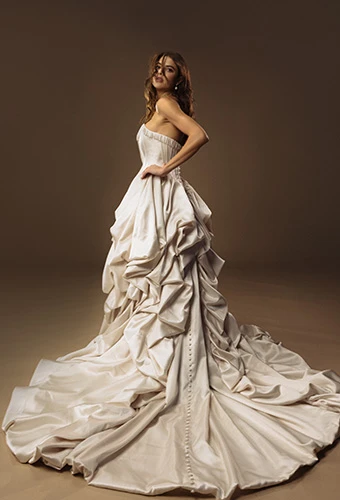 Bride wearing strapless bronze gown with crinkled tafetta