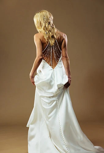 Bride wearing satin sheath wedding dress with open back and pearl strands, All Who Wander richie