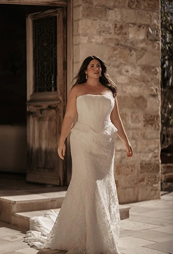 Plus size bride wearing strapless fit-and-flare wedding dress in lace with peplum waist detail, Martina Liana ML2042+