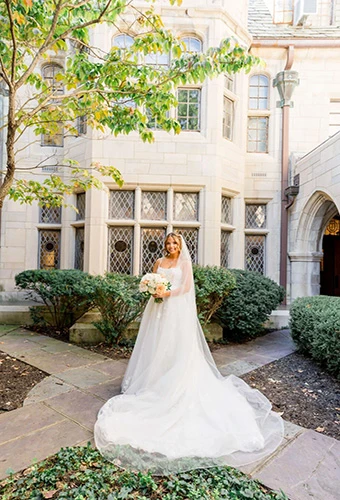 Real bride Janet Elizabeth wearing a voluminous tulle ballgown with royal train on her wedding day