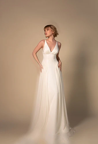 Bride wearing soft A-line wedding dress with drop waist and thick straps, All Who Wander gisele