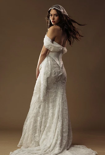 Bride wearing column wedding dress with beaded lace skirt and draping