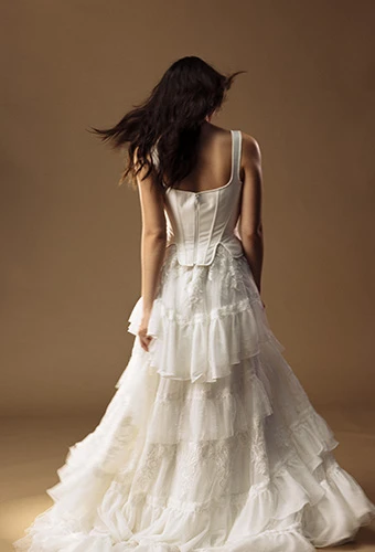 Bride wearing lace A-line wedding dress with corset bodice and zipper closure, All Who Wander winona