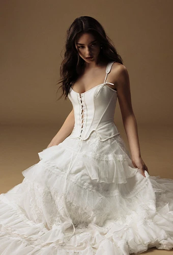 Bride wearing faux two piece wedding dress with lace up corset and lace skirt