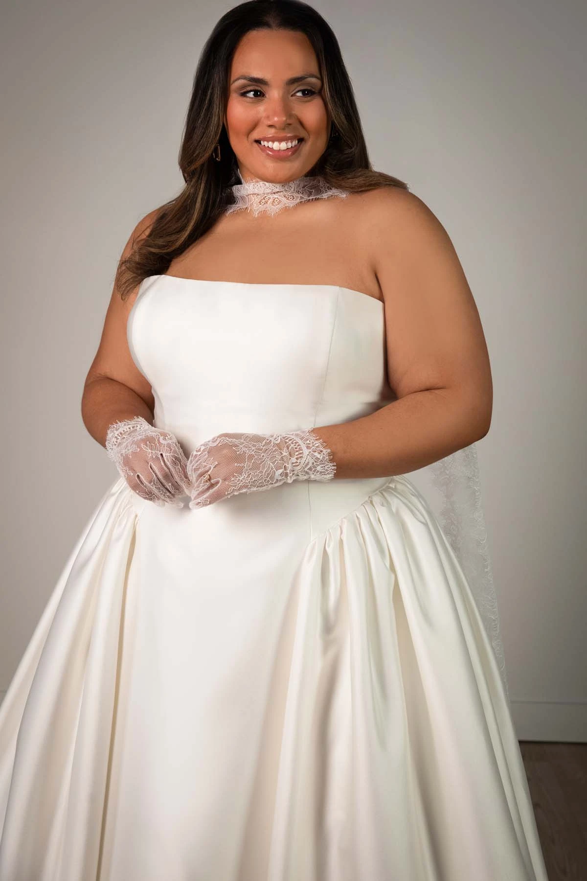 sy8274+ Plus Size Strapless Mikado A-Line Wedding Gown with Architectural Seaming and Pockets by Stella York