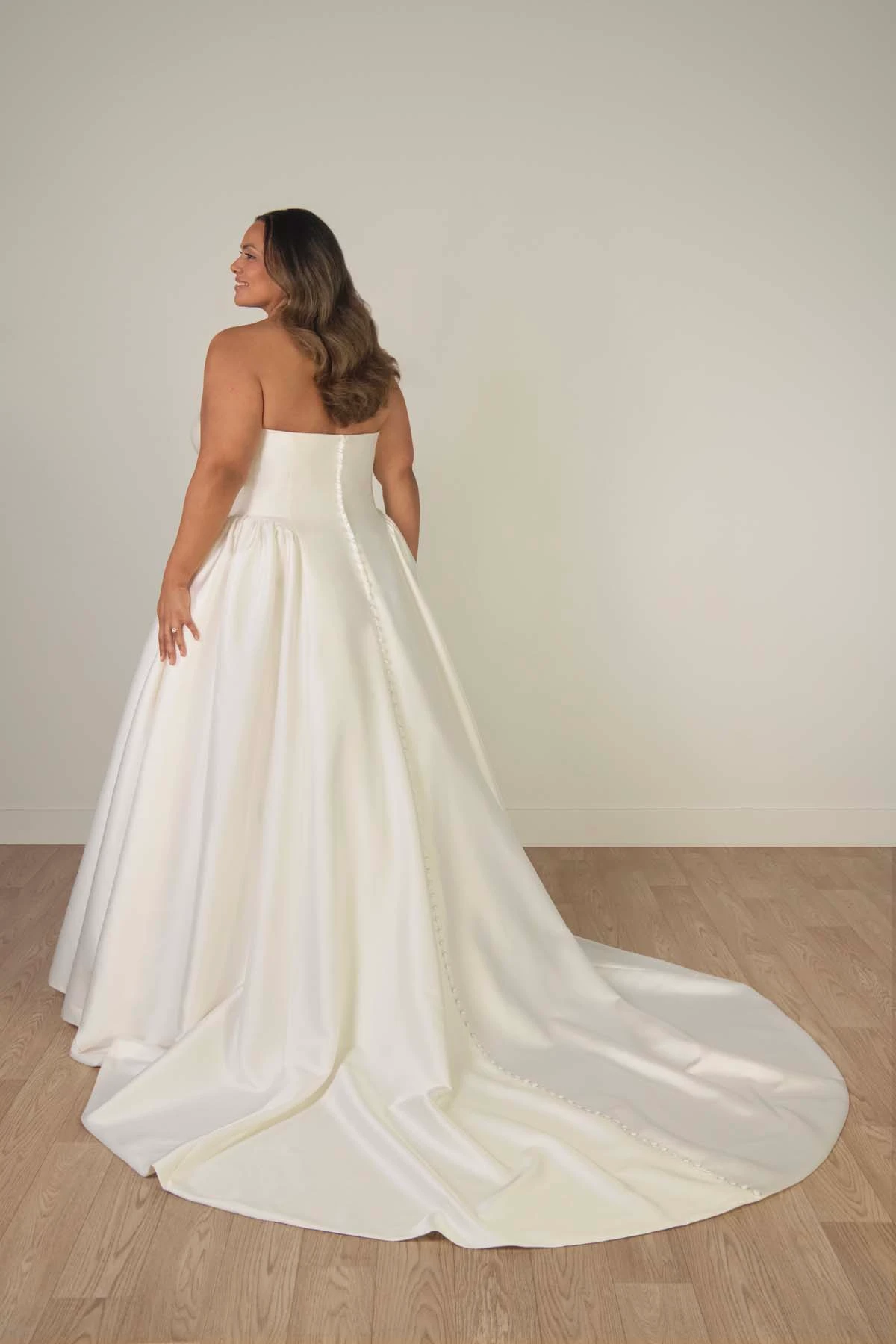 sy8274+ Plus Size Strapless Mikado A-Line Wedding Gown with Architectural Seaming and Pockets by Stella York