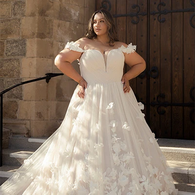 Bride wearing plus size tulle ballgown wedding dress with 3D florals