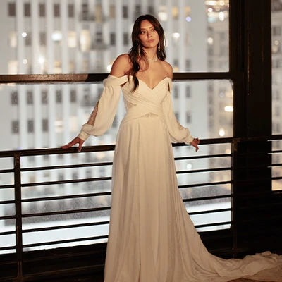 Bride wearing boho chiffon and lace a-line wedding dress with detachable sleeves