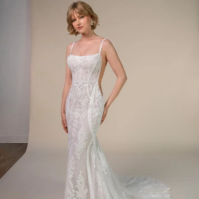 Bride wearing boho lace fit-and-flare wedding dress with open back
