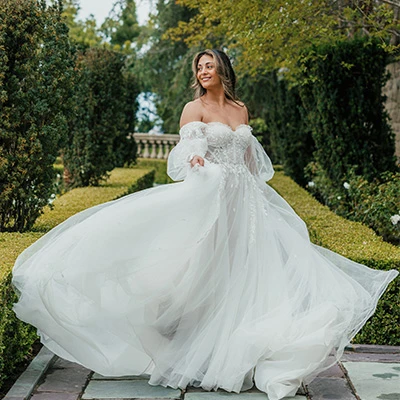 Bride wearing boho a-line wedding dress with long sleeves