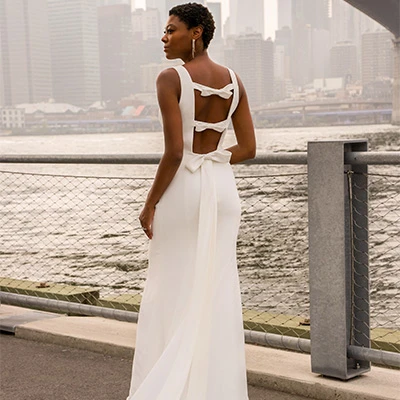 Bride wearing modest column wedding dress with low back detail