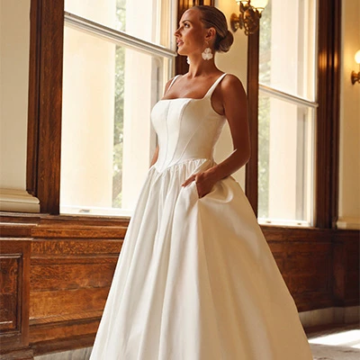 Bride wearing modern square neckline princess ballgown wedding dress with pockets